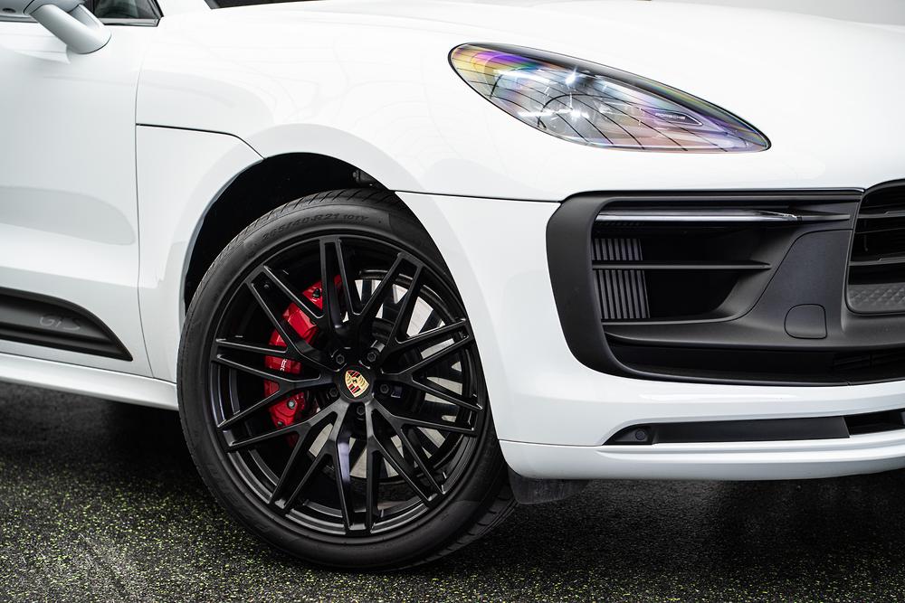 Closeup shot of a Porsche rim with the headlight also in frame