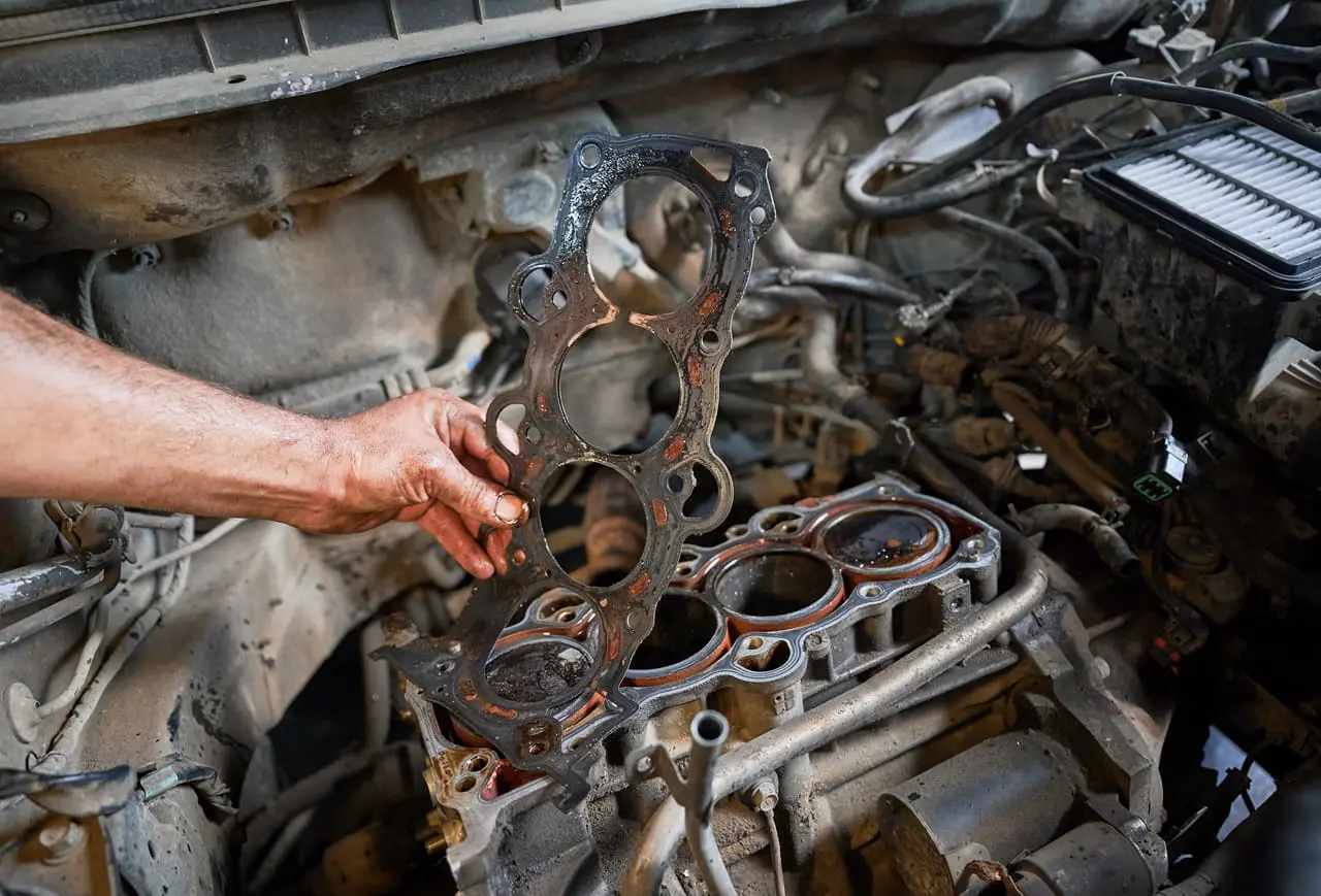 Image showing a worn/dirty head gasket with the engine in the background